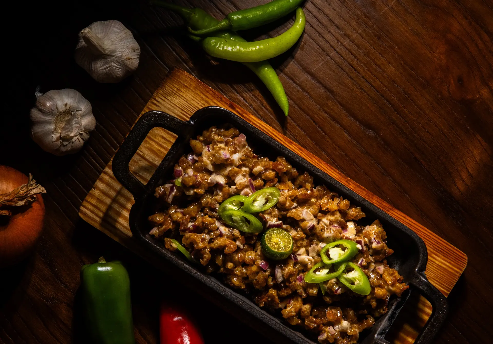 Sizzling sisig on cast iron at Amerino